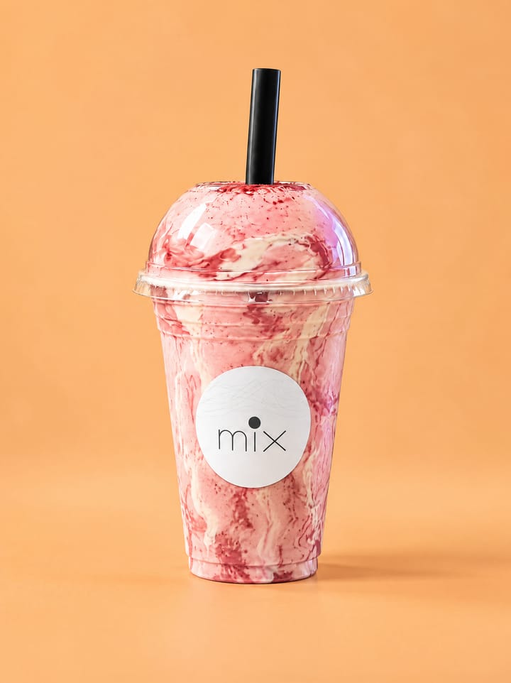 Concept styling for Strawberry Cheesecake: a MIX cup on a colored backdrop (illustrative, not a photo of the actual drink)